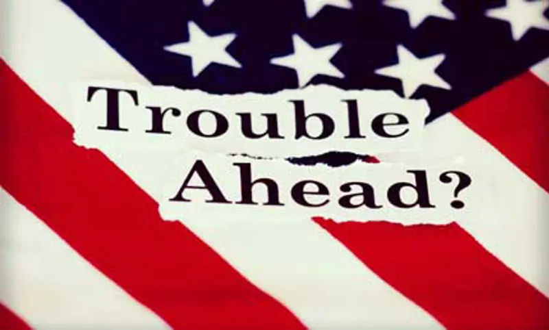 Picture of the American flag with words on top saying "Trouble ahead?"