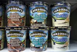 Two rows of Ben & Jerry's ice cream tubs in various flavours.