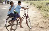 two boys on a bicycle