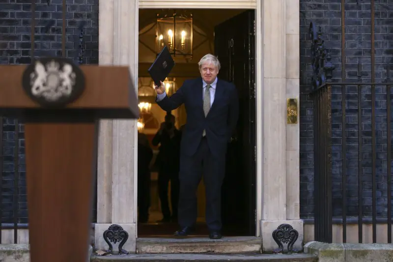 Man in a doorway holding a file